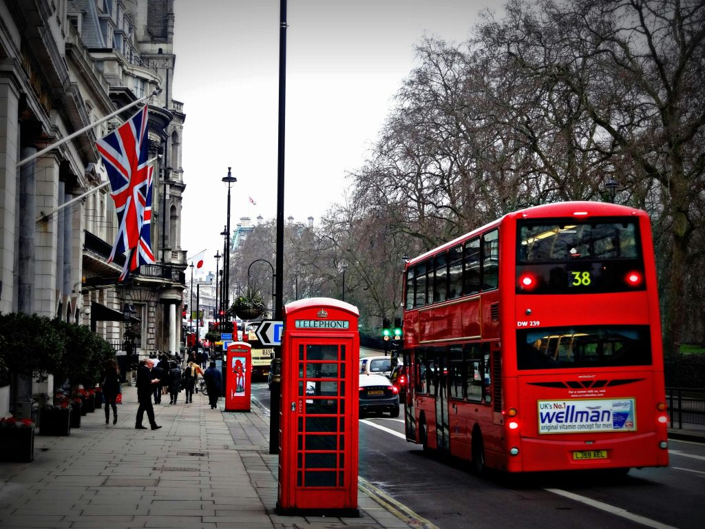 london-street-phone-cabin-163037-163037 Classic London scene featuring a red double-decker bus and iconic phone booth on a busy city street.